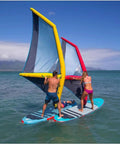 People using Inflatable Surf Wing For Wind Wing Foiling And Surfing, 4.2 Square Meters on paddleboards, blue and red wings visible.