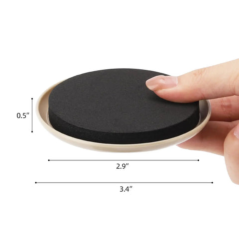 Close-up of 20 Pack Carpet Furniture Sliders 3.5 Inch Round Moving Pads with black EVA foam and beige plastic base held by a hand