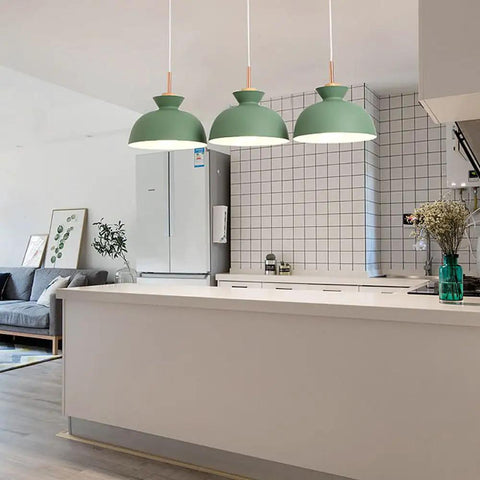 Three 11inch Wood Pendant Lights in matte green hanging over a modern kitchen island, stylish Nordic decor for farmhouse.