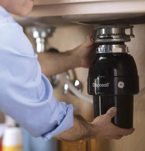 Person installing Disposall Garbage Disposal With Continuous Feed 0.5 HP Motor under a kitchen sink