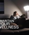 Person reading by 10000 Lux Therapy Lamp For Mood And Energy Boost, Sunlight Box Light Therapy with adjustable brightness.