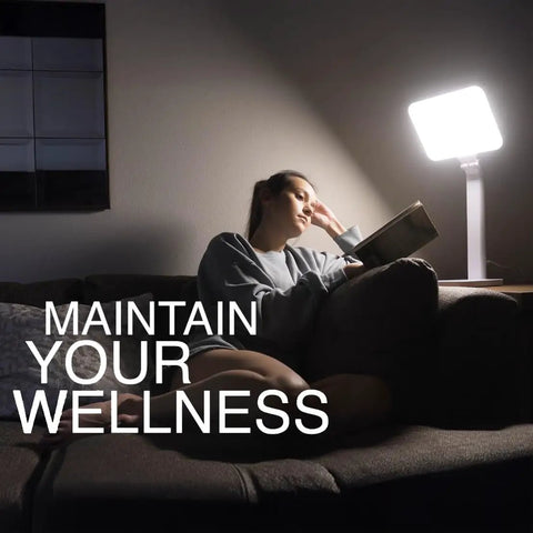 Person reading by 10000 Lux Therapy Lamp For Mood And Energy Boost, Sunlight Box Light Therapy with adjustable brightness.