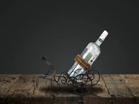 Handmade Asian Style Rickshaw Puller Wine Bottle Holder With Natural Rattan Accents, supports a wine bottle on a rustic surface.
