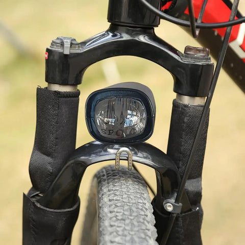 Rock Your Ride With This Super Cool 2 In 1 Waterproof E Bike LED Headlight That Doubles As A Loud Horn For Safety On Any Scooter Motorcycle Or Bicycle Out There mounted on a black bike fork