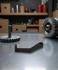Dead Nuts Accurate Tire Balancing Ruler Crank Handles Built Different With Soft Touch Polymer Grips For Wheel Tech Teams And Local Mechanic Shops Straight Up Diagnostic Gear That Gets The Job Done Right. Close-up of black crank handle on a work surface with gears.