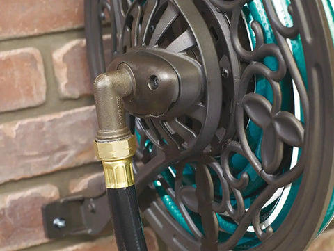 Close-up of a decorative brown hose connection in the NeverLeak Decorative Wall Mount Hose Reel in brown for outdoor yards