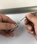 Hands attaching a steel cable to a hook from Click Rail Picture Hanging System Kit With Two White 59 Inch Rails Four Steel Cables Six Hooks