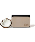 Drift beige stone car air freshener with metal clip on a black backing; coconut half beside it.