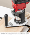 Knockout Performance Phenolic Trim Router Base for Compact Palm Routers on wood, showcasing massive grip handle and sleek design.