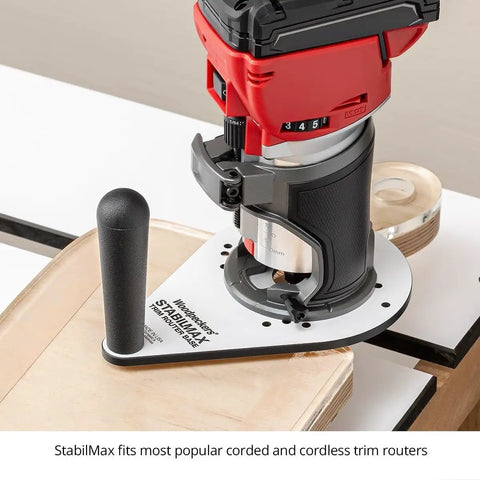 Knockout Performance Phenolic Trim Router Base for Compact Palm Routers on wood, showcasing massive grip handle and sleek design.