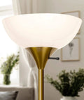 Dimmable LED Floor Lamp With 3000K Warm White Light, torchiere style in brass gold finish, sky dome shape in living room setting.