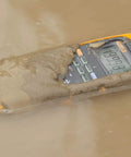 Pro Grade True RMS Digital Multimeter Kit submerged in muddy water demonstrating IP67 waterproof and dustproof feature.