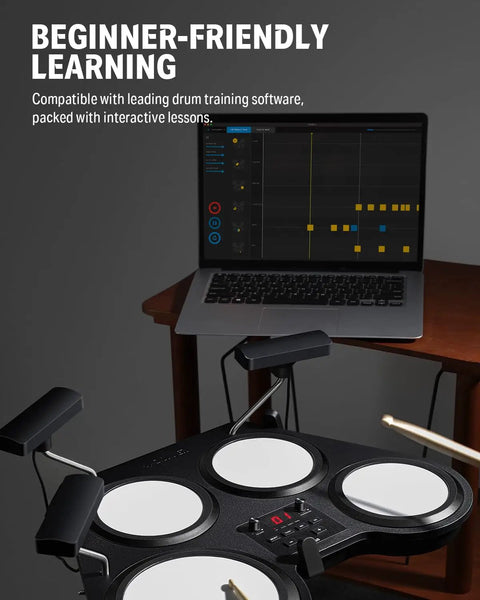 Beat Go Portable Electronic Drum Set With Training Lessons For Beginners next to a laptop showing drum training software.