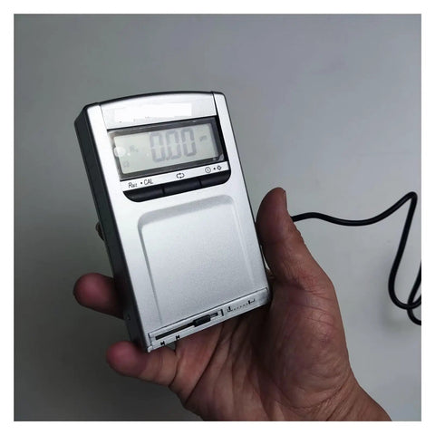 Slick Pocket Sized Surface Roughness Tester Heavy Duty Digital Gauge for Metal Wood Plastic Texture Analysis held in hand.
