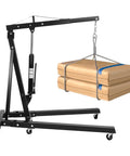 Shop Ready 2 Ton Folding Hydraulic Engine Hoist And Cherry Picker Crane lifting boxes with steel frame and swivel rollers.