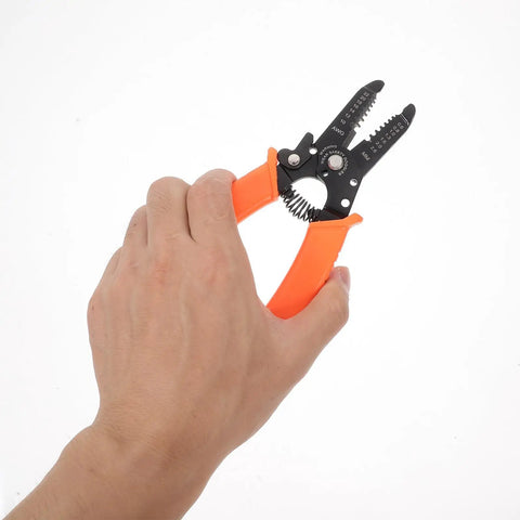 Tough As Nails Wire Stripper Pliers With Cushioned Safety Lock And Stainless Steel Blades held in hand for stripping insulation.