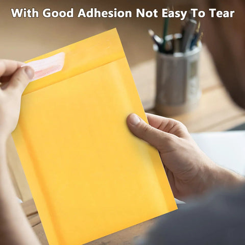 Person holding Yellow Self Seal Bubble Mailers 4x8 Exterior 4x7 Inner Padded Envelopes 100 Pack For Small Biz Shipping Jewelry And Electronics Opaque Lightweight Durable