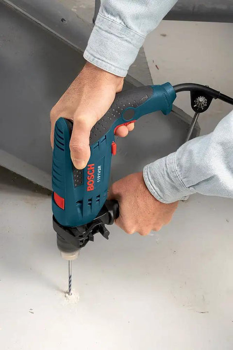 Person using 120 Volt One Half Inch Hammer Drill With 7 Amp Motor Lightweight Workhorse Single-Speed 360 Degree Auxiliary Handle on concrete