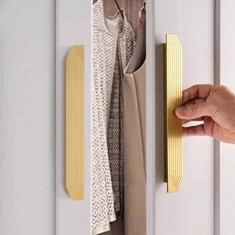 Hand using Brushed Gold Cabinet Pulls 9.75 Inch Polygon Drawer Handles 2 Pack With Screws on a white cabinet door