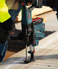 Bosch HC4C2083 1/2 in x 8 in SDS-Plus Bulldog bit installed in blue rotary hammer drilling into concrete
