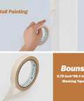 Person applying 0.75 inch masking tape for DIY Ready 17 Piece Paint Roller Kit With 9 Inch And 4 Inch Rollers, Trays, Frames, Microfiber Covers, Brushes, Self Dip Handle, And Sandpaper For Easy Indoor Wall Painting And Home Improvement.