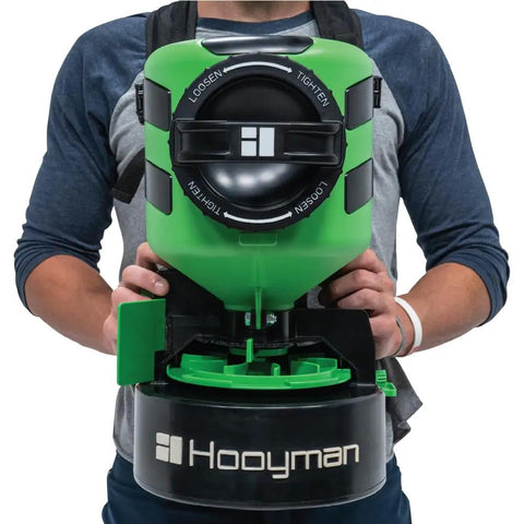 Person wearing Lithium Ion Chest Spreader With Harness System, Adjustable Feed Rate, 24 Volt Power, 35 Pound Hopper, Ideal For Lawn Care