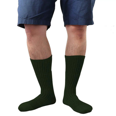 Person wearing heavy duty military grade boot socks, green, size 10 to 13, for combat training and work duty.