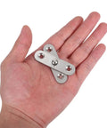 Hand holding stainless steel folding butt hinge, showing size of product for cabinets and furniture, six pack space saving design.