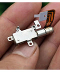Close-up of compact High Precision 5mm Gearbox Stepper Motor With 8mm Stroke Linear Actuator for cameras and phones in hand.