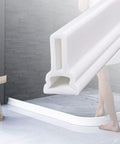 Built Tough Silicone Water Stopper For Bathtub And Sink Drainage, flexible waterproof seal strip in a modern bathroom setting.