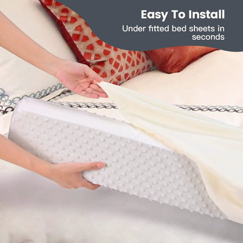 Hand placing Rock Solid Toddler Bed Guard Rails And Foam Bumpers for Kid Safety under fitted sheet, grey foam pad.