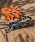 Heavy Duty Metal Keychain Set With Carabiner Clip, Bottle Opener And Three Key Rings on wooden surface