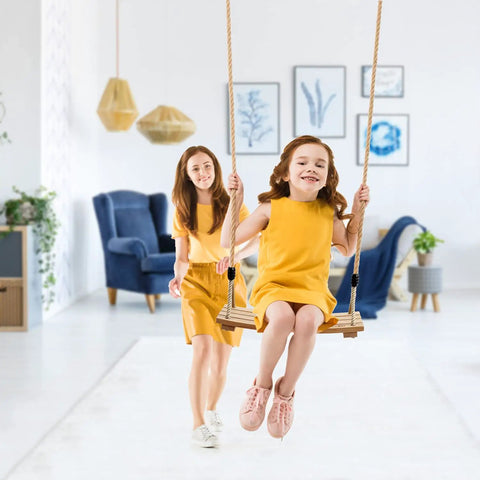 Child using Wooden Tree Swing Seat For Indoor And Outdoor Fun with adjustable rope, non slip ridged seat in a living room setting