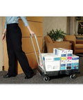 Person transporting boxes with Triple Trolley Heavy Duty Utility Cart, 500 lb capacity, flat-folding design, black finish.