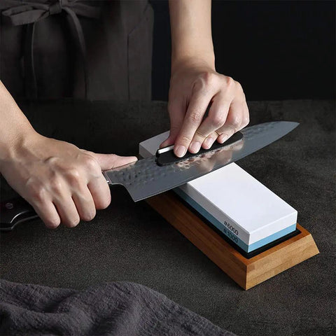 Two Sided 1000 And 6000 Grit Whetstone Knife Sharpener Kit With Non Slip Bamboo Base And Angle Guide in use with kitchen knife