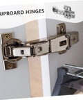 Stainless steel cabinet hinge with hydraulic buffer, mounted on a kitchen cabinet door (close-up)