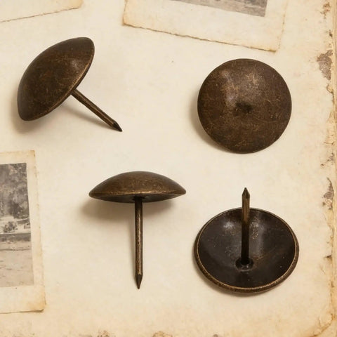 Heavy Duty Antique Brass Upholstery Tacks For Diy Furniture Repair Leather Crafting Auto Interiors Includes Thirty Solid Metal Clavos with round heads on a textured background.