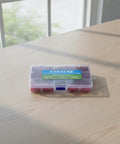 Pro Level Badminton Racket Grommet Stringing Tube Storage Case With Secure Blue Latch To Keep Essentials Organized And Safe No Sweat During Restringing Projects For Hobbyist Or Shop Bench Replacement Use In Vivid Red Color, clear plastic case, 17.5 x 10 x 2.5 cm