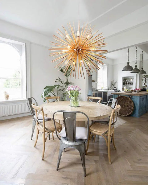 Dope Gold Sputnik Chandelier Light Fixture With 12 E12 Holders hanging over round dining table in modern kitchen setting.