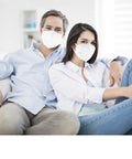 Couple wearing KN95 Face Masks 50 Pack Individually Wrapped White 5 Layer Protection Cup Style For Adults Men Women Indoor Outdoor Use Dust Safety Mask Great For Travel On The Go And Everyday Errands, sitting on sofa.