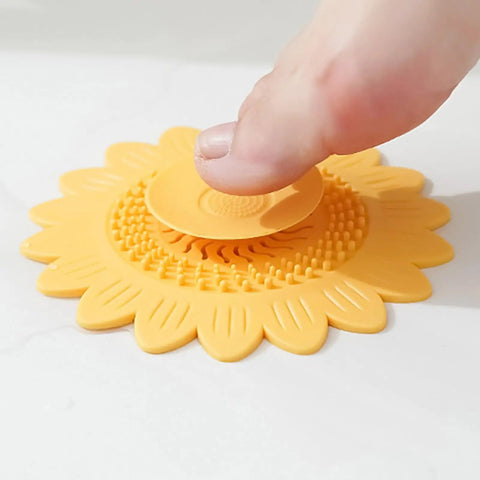 Floor Drain Plug Shower Bathtubs Drain Covers, Flower, White with a finger pressing down on the suction part on a wet surface.