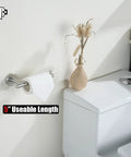 Sturdy 304 Stainless Steel Toilet Paper Holder With 5 Inch Roll Capacity, Brushed Nickel Wall Mount, next to a toilet.