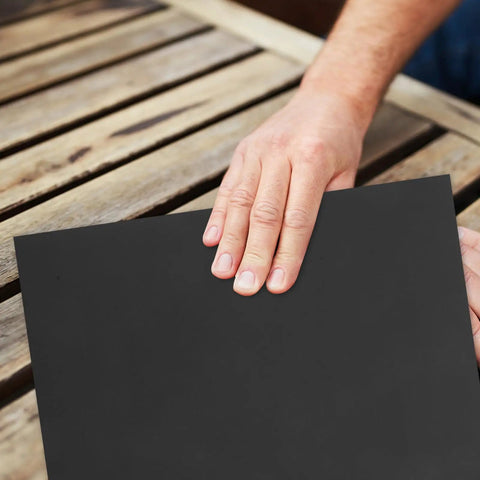 Fine Grit Sandpaper Sheets For Woodworking And Crafts With Smooth Finish, held on a wooden table for project use.