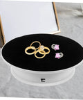 Rotating Electric Turntable Display Stand With Smooth Motorized Motion showcasing gold and silver rings on a black velvet top.