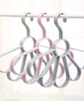 Fan Shaped Closet Rod Organizer For Ties Scarves And Hats Made From Sturdy Polypropylene hanging in light colors.