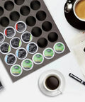 Neat 40 Pod Coffee Pod Organizer Drawer Tray for K Cup Keurig Pods on counter with coffee cup and newspapers