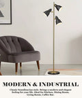 Dope Gold Tree Floor Lamp With Three Adjustable Rotating Lights standing beside a gray chair in a modern living room setting