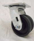 Swivel caster with 4in diameter, 2in wide black V-groove iron/steel wheel on a silver mounting plate