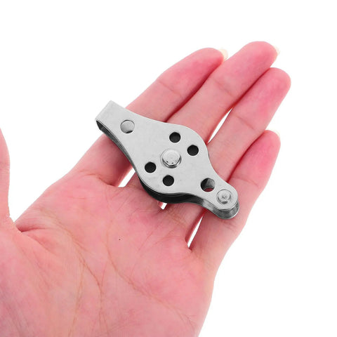 Hand holding stainless steel pulley wheel from Stainless Steel Pulley Wheels 2 Pack For Kayaks And Canoes, Beefy Heavy Duty Marine Deck Hardware