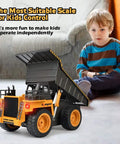 Young boy playing with Remote Control Dump Truck For Kids And Toddlers, Realistic RC Construction Vehicle, indoors